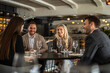 © Creative Light - Group of friends enjoying a meal and conversation at a stylish restaurant
