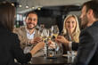 © Creative Light - Friends toasting with wine glasses at a restaurant, celebrating together