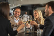 © Creative Light - Friends toasting with wine glasses at a restaurant, celebrating together