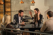 © Creative Light - People arguing at a restaurant table, conflict and disagreement concept