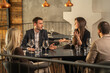 © Creative Light - Business colleagues in a restaurant having a discussion during a meeting