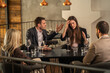 © Creative Light - People arguing at a restaurant table, conflict and disagreement concept