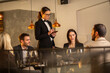 © Creative Light - Elegant restaurant scene with a server taking an order from a group of friends