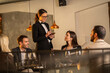 © Creative Light - Waitress taking an order from customers at a restaurant table