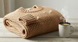 © PixelProCreative - Cozy beige knitted sweater folded on a wooden table with a cup of hot coffee, creating a warm and inviting atmosphere