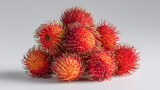 Fresh rambutan fruit pile on a solid light gray background, studio shot, This vibrant image showcases a pile of fresh rambutans, ready to be enjoyed as a healthy snack or  ingredient.