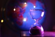 © Elena K - The hourglass sand glass as symbol of passing time and the globe travel photo