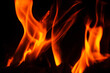 © dimas830 - Vibrant flames dancing against a dark background, creating a mesmerizing display.