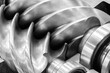 © Aleksandr Matveev - A large gear with a spiral pattern. gear is silver with a black center. gear is part of a mechanism. Industrial concept background.
