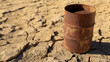 © A2Z AI  - A weathered metal barrel rests on arid, cracked earth. Its rusty surface contrasts with the dry landscape, hinting at scarcity and environmental challenges in a parched world.