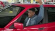 © Vlad - Smiling taxi driver putting yellow taxi car sign on the roof.