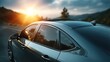 © Oulaphone - A sleek car parked on a scenic road at sunset, showcasing modern design and reflective surfaces against a picturesque landscape.