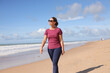 © Tororio Stock - Woman enjoying beach walk under blue sky