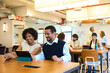 © alvaro - Diverse business team collaborating on tablet in modern office