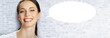 © vgstudio - Facer portrait image - very happy, joyful, expressive smiling beautiful woman. Cute brunette hair girl stand against bricks wall background with white mockup empty speech bubble. Free ad text space.