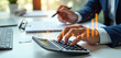 © Vadym - Businessman uses calculator and tablet for financial analysis. Orange graphs show rising business growth and investment charts. He plans budget, reviews income, expense data, working in office.