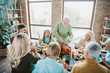 © deagreez - A warm family Thanksgiving gathering around a table sharing a roasted turkey joy laughter and gratitude in a bright cozy home setting