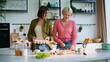 © stockbusters - Happy friends cooking together in kitchen closeup. Ladies watching culinary show