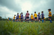 © Vadym - Kids rugby match on green field. Young players in uniform ready to play together. Children learn teamwork, sport activities. Junior league competition. Boys play in sports game. Team spirit concept.