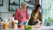 © stockbusters - Cooking sisters standing kitchen closeup. Happy rejoicing girls preparing salad