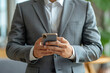 ©  A-photos - スマートフォンを操作するスーツ姿の日本人男性（ビジネスシーン）