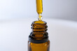 © Wellness Visuals - Macro shot of CBD oil drop and amber glass bottle, minimal wellness composition.
