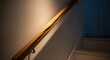 © Kharis - Dramatic lighting highlighting a prominent split in an old wooden banister on an interior stairway