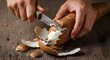 © Nique - Hands peeling cassava root on rustic wooden surface