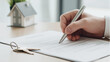 © Elen Nika - Close-up of hand signing a real estate contract with keys and a miniature house model nearby. Property transaction, signing the legal documents, real estate contracts, legal processes
