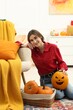 © New Africa - Happy Halloween. Woman with Jack-o'-lantern pumpkins at home