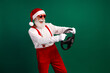 © deagreez - Cheerful Santa Driving Imaginary Car in Winter Festive Attire on Green Background