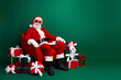 © deagreez - Santa Claus enjoying holiday vibes in stylish attire with gifts in a festive red and green themed decor