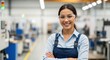 © Vasiliy - Confident female factory worker smiling at the camera. Young asian engineer in safety glasses and overalls in a modern manufacturing plant