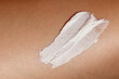 © LeviaUA - Close-up of a womans skin with a smear of exfoliating body scrub