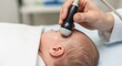 © Olga Ко - Newborn Cranial Ultrasound. Close-up of a neurosonography procedure on an infant's head performed by a pediatrician in a clinic