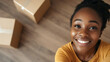 © photo for everything - A cheerful young woman is moving in! With a bright smile, she's ready to start a new chapter. Boxes surround her on the wooden floor, symbolizing new beginnings and exciting adventures.