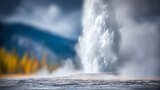 A powerful geyser erupts, spewing water and steam into the air against a backdrop of natural beauty.