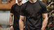 © Studicon - Two muscular men wearing black t-shirts, standing outdoors