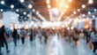 © Studicon - Blurred image of people walking in a convention center with bright lights