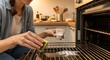© Tomy - Woman cleaning oven racks with baking soda, DIY oven cleaner, Housewife scrubbing oven grill