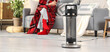© Pixel-Shot - Electric heater on floor against woman with plaid sitting at home, closeup