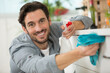 © auremar - portrait of handsome man cleaning the home