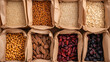 © A2Z AI  - Assorted dried goods fill brown paper containers, displaying a variety of grains, legumes, nuts, and fruits in an organized manner. The different colors and textures add visual appeal.