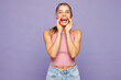 © ViDi Studio - Young happy woman wears pink tank top casual clothes scream sharing hot news about sales discount with hands near mouth isolated on plain pastel purple background studio portrait. Lifestyle concept.