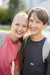 © Westend61 - Smiling siblings with backpacks outdoors after school