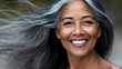 © A2Z AI  - A beautiful mature woman smiles radiantly, her silver hair gracefully blowing in the wind, showcasing natural aging and timeless elegance. She is captivating and confident.