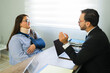 © AntonioDiaz - Client discussing personal injury claim with lawyer in office