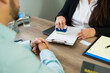 © AntonioDiaz - Closeup of immigration official stamping visa application form for client