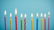 © Chiyaki - Colorful birthday candles with glowing flames, creating a festive and celebratory atmosphere.