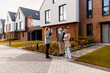 © Maria Vitkovska - Real estate agent showing new modern townhouses to young couple